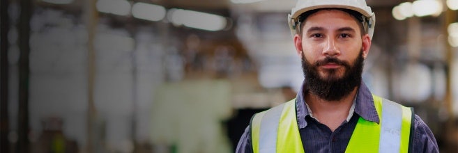 A person wearing a safety vest and hardhat Description automatically generated