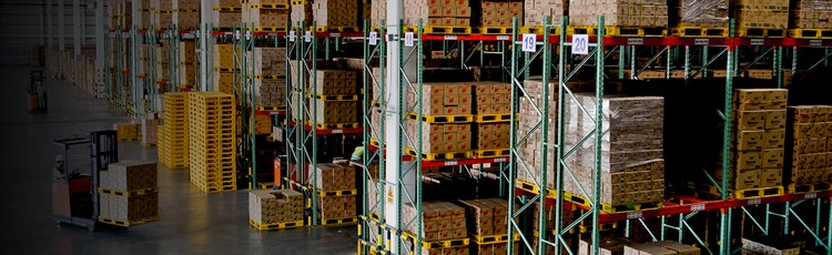 Numbered shelves in a warehouse where they are holding boxes for inventory